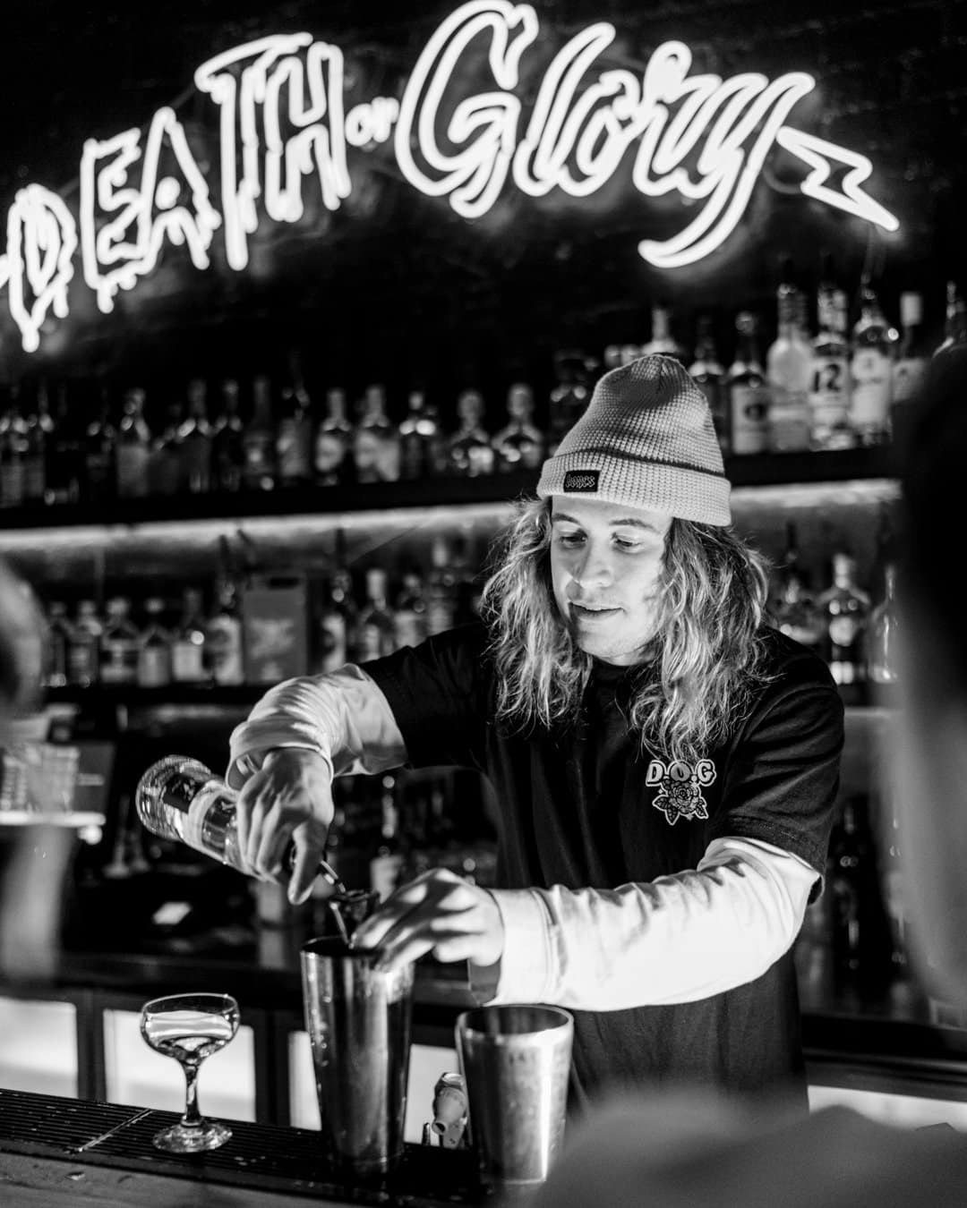 Drink photography of bartender making a cocktail from a bar marketing campaign.