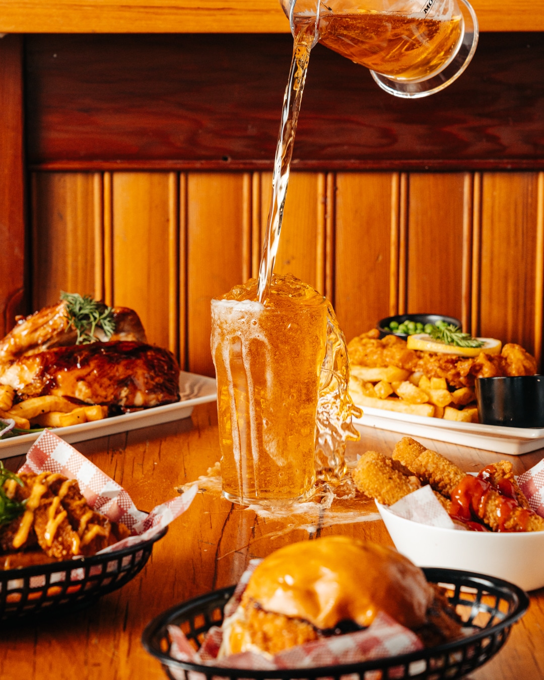 Drink photography of a jug of beer being poured into a glass from a bar marketing campaign.