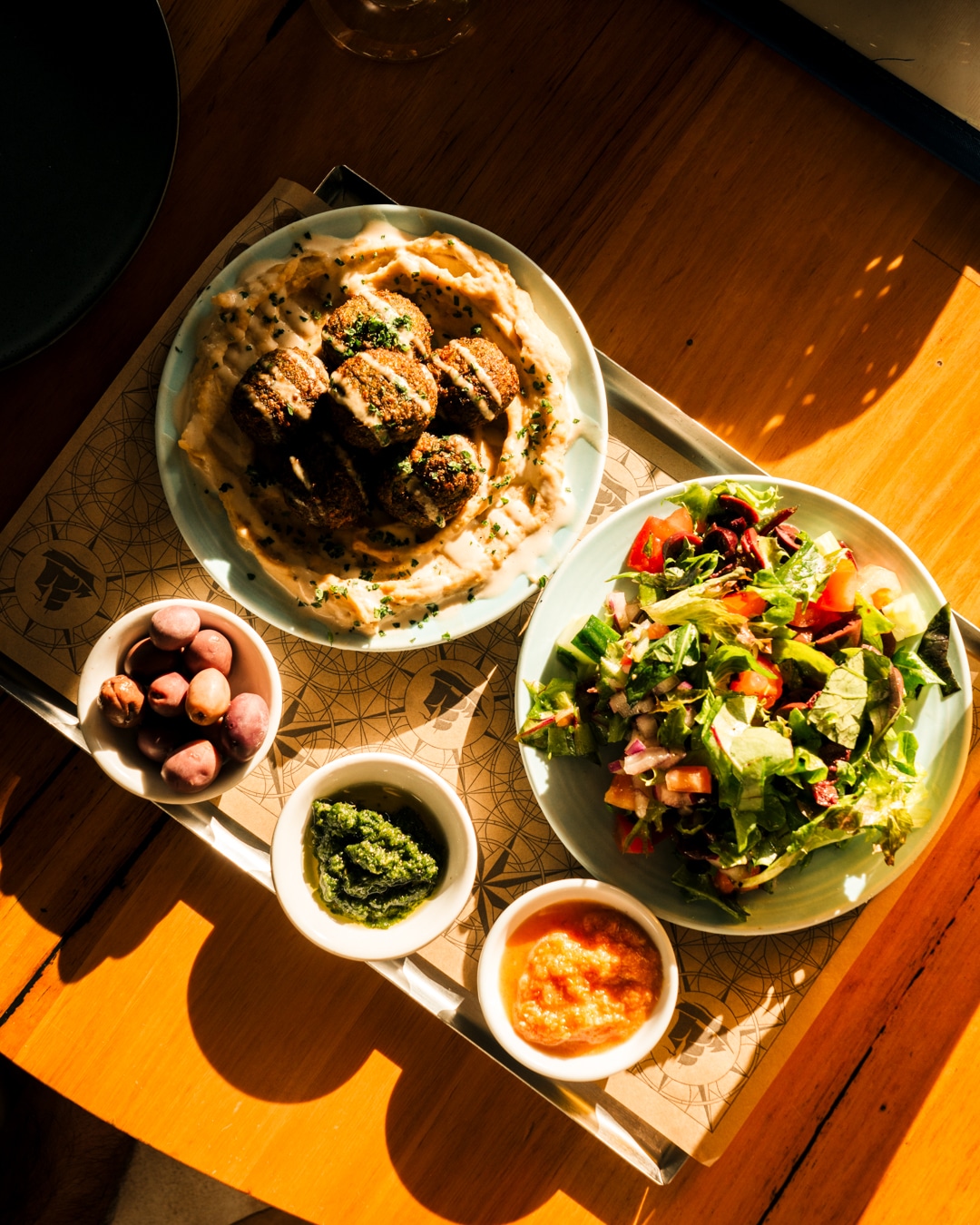 Food photography of collection of dishes on a table from a restaurant marketing campaign.