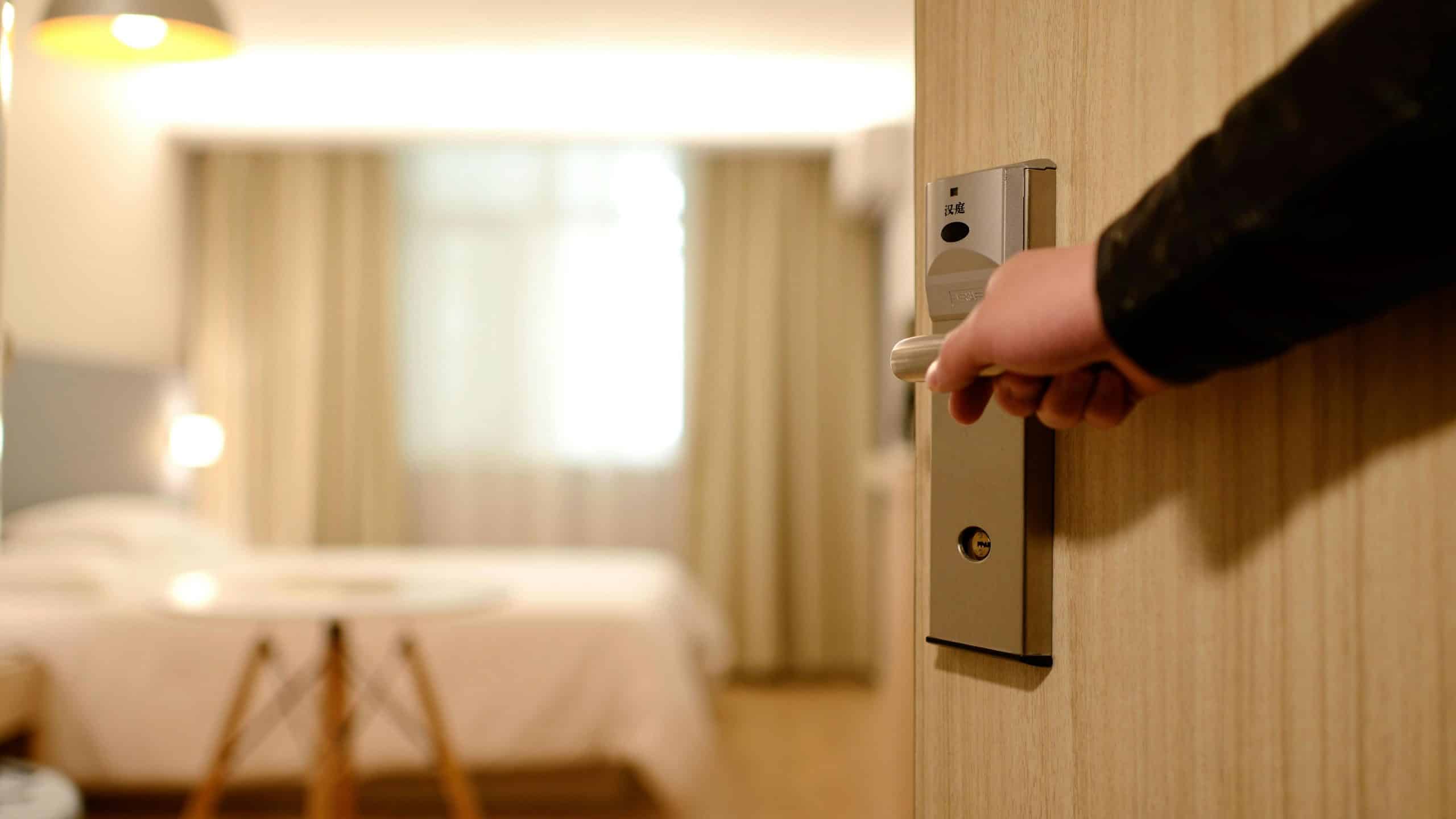 hand opening door handle to hotel room