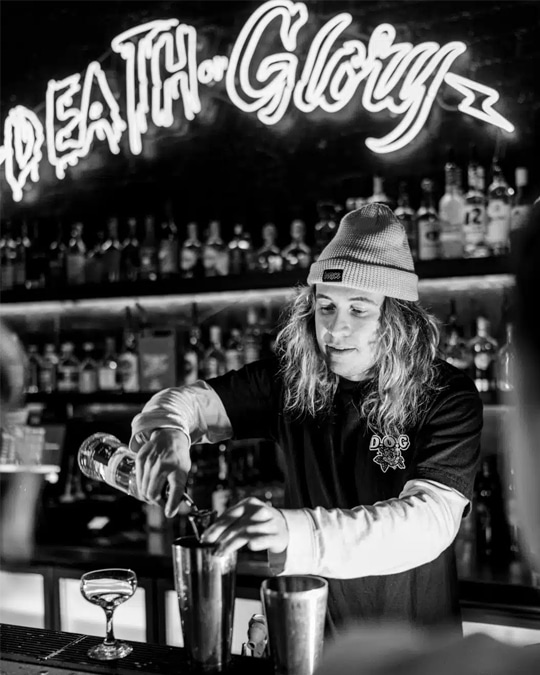 Drink photography of bartender making a cocktail from a bar marketing campaign.